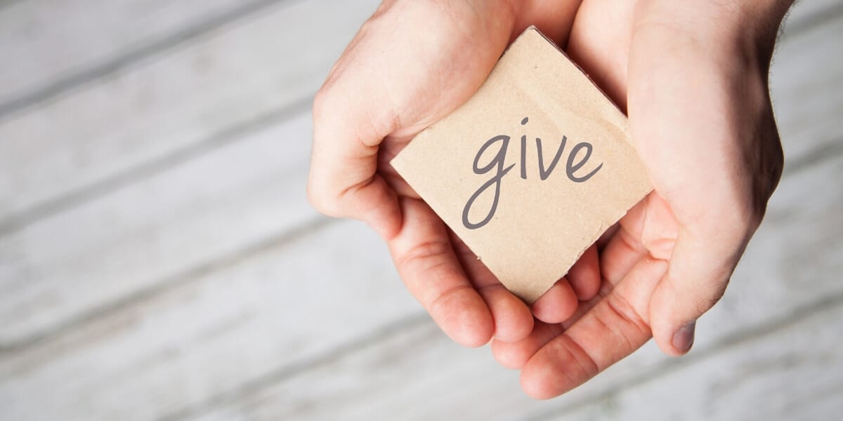 hands with note that says give