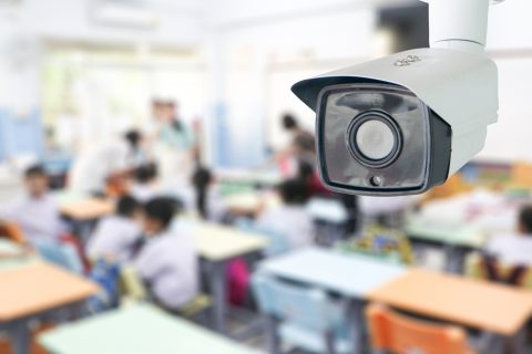 A surveillance camera in a classroom with students.