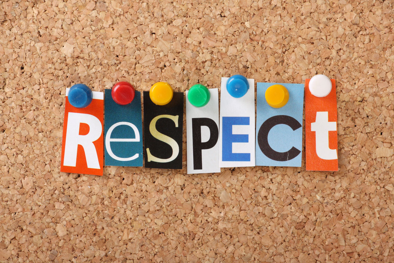 The word respect thumbtacked to a corkboard. Each letter of the word is different in shape and color.