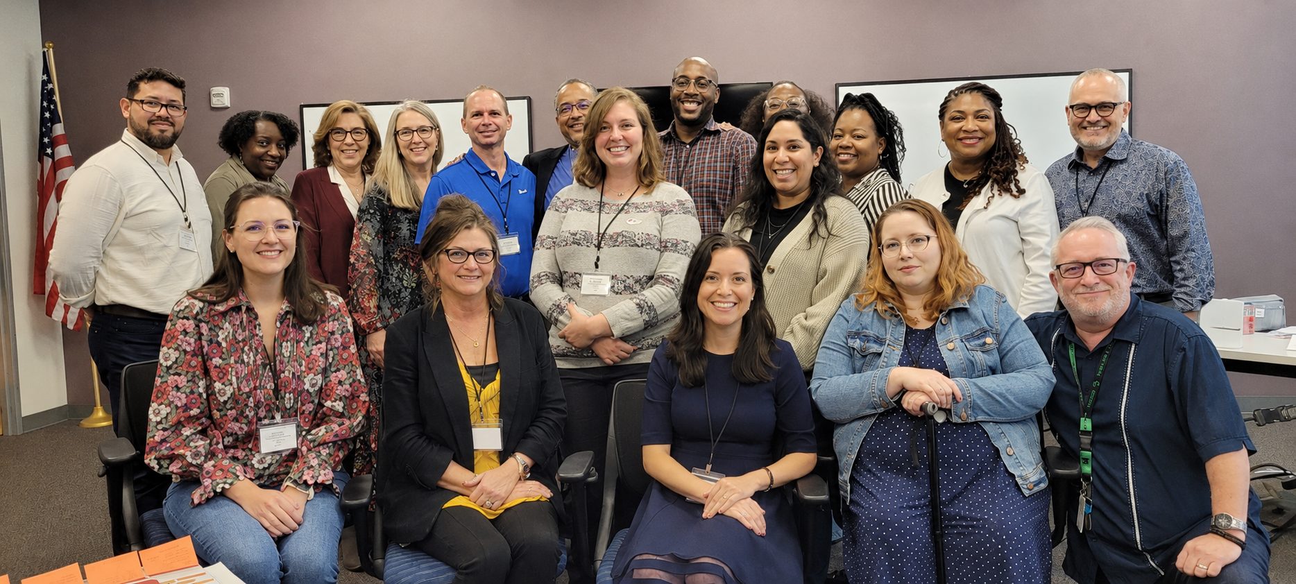 A group of about 20 DRTx staff members posing for a photo in a conference room.
