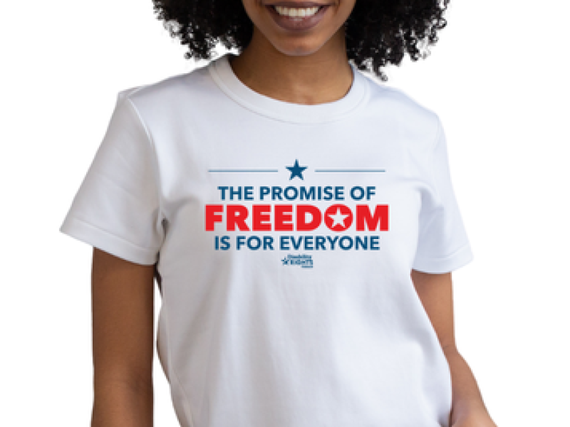 A model wearing a t-shirt that says the promise of freedom is for everyone.